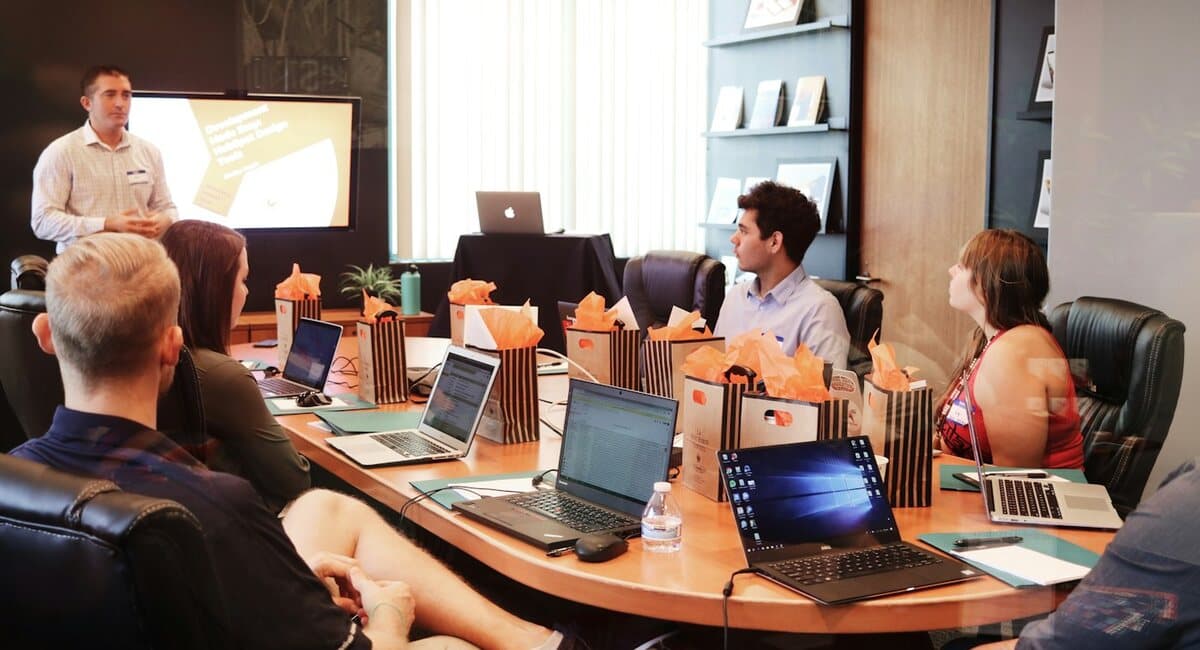 A technical leader presenting to colleagues in a meeting room
